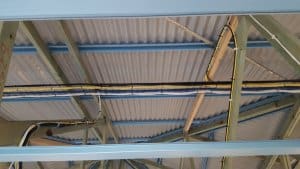 Example of cabling in a roof. Cable attached to beams.