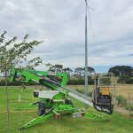 boom lift in front of free standing antenna