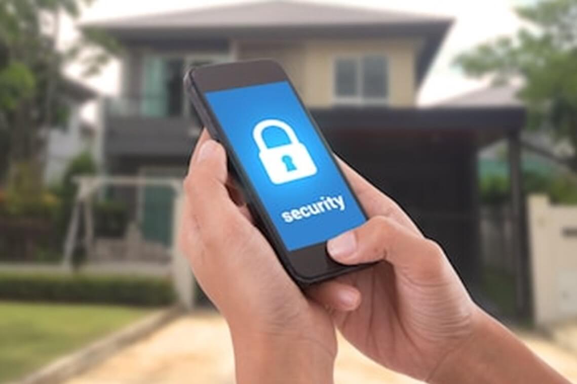 Someone arming the security system for their house via an app on their phone